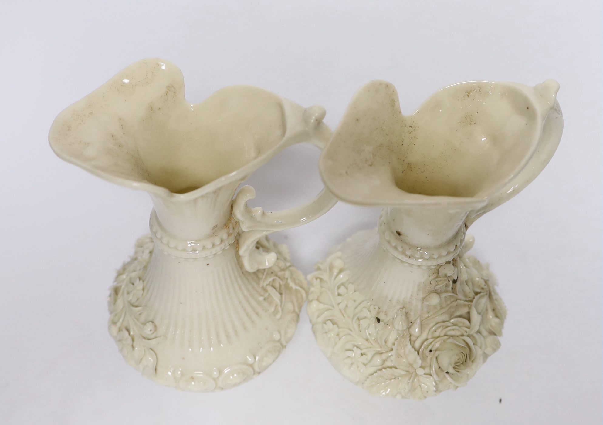 A pair of Belleek jugs with applied rose decoration, 19 cm high
